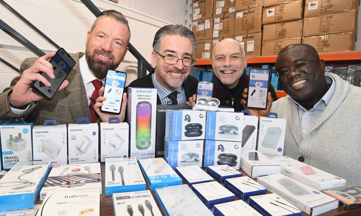 The Gibutech team with phones and boxed accessories in the warehouse