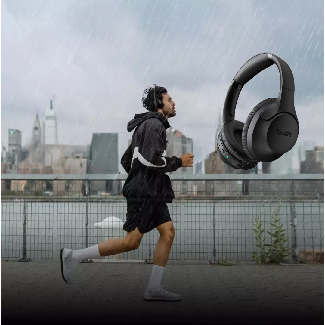 Man running in the rain beside the balln audio noise cancelling headphones