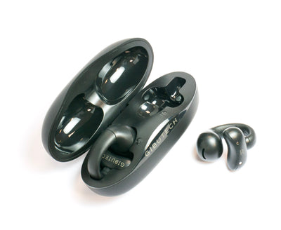 Black Gibutech Ultra Open earbuds beside their open charging case